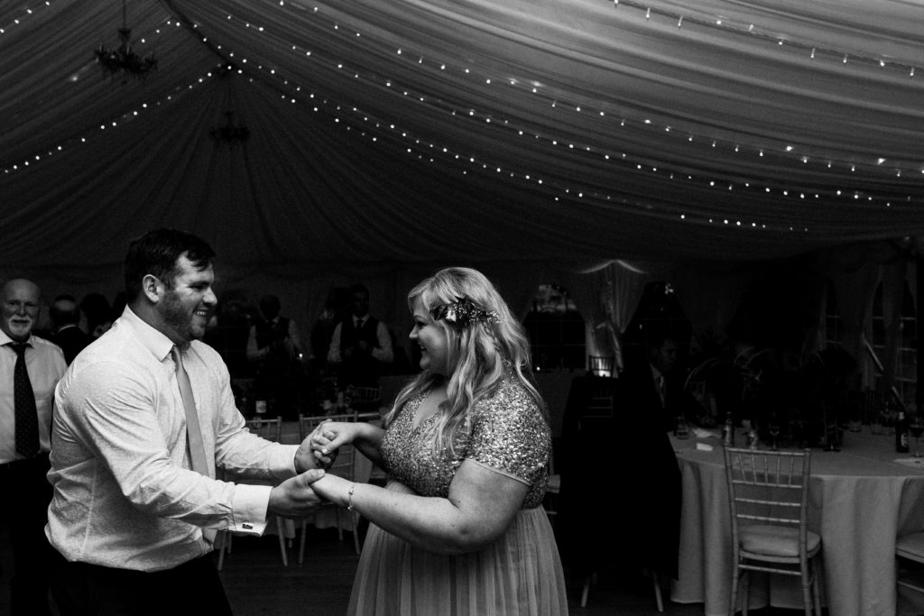 bridesmaid and her partner dancing at the wedding reception at Boswell's Coach House