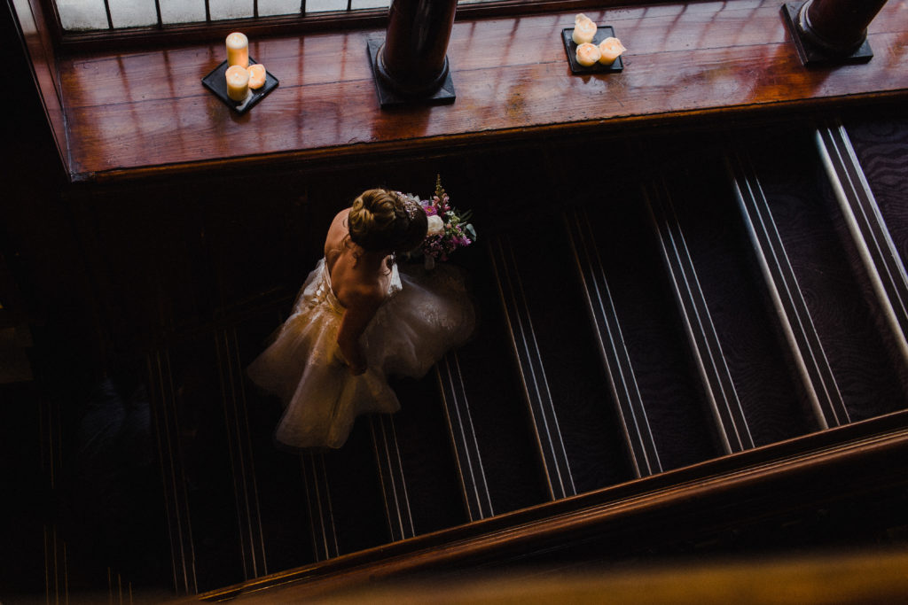 bride walking up the stairs at Sloan's Glasgow to her wedding ceremony