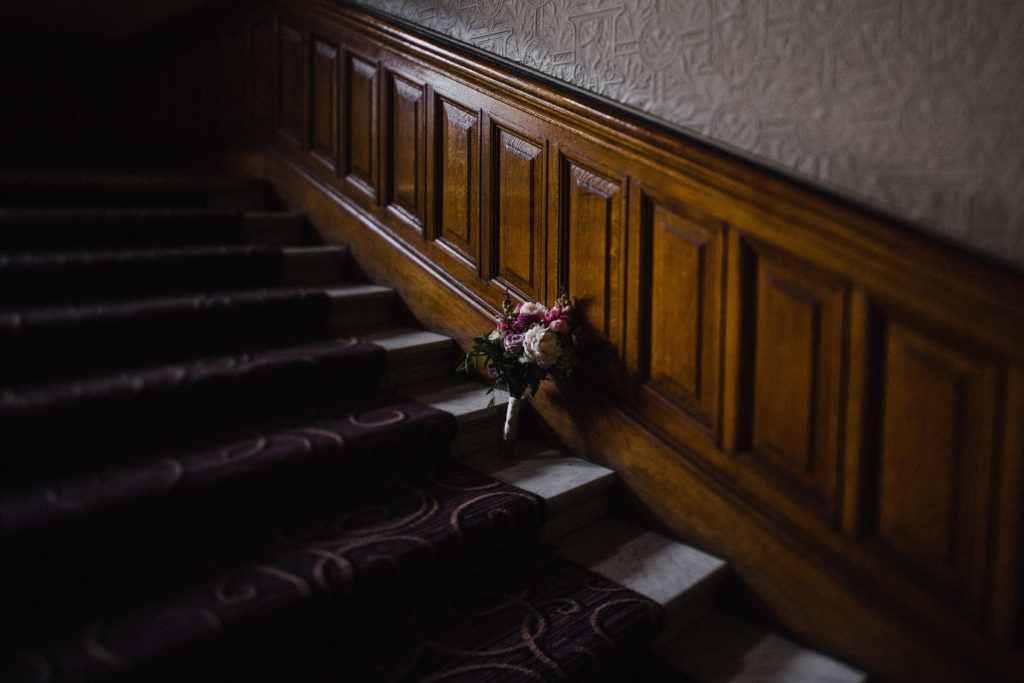 wedding flowers on the staircase at Grand Central Hotel Glasgow