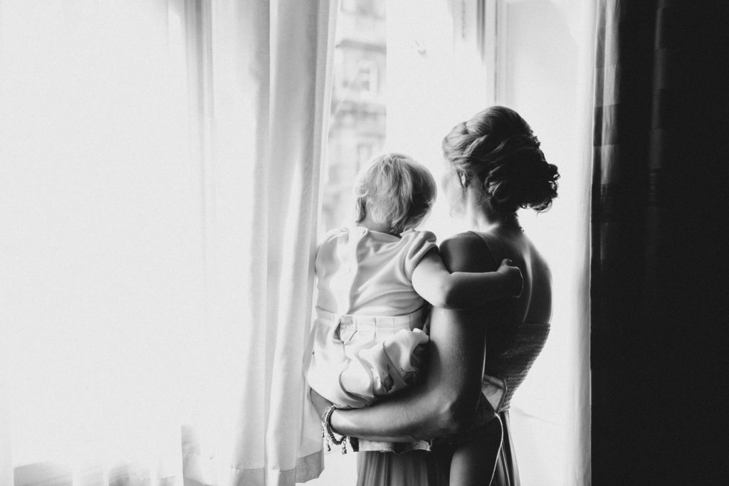 bridesmaid and flower girl looking out of the window at Grand Central Hotel Glasgow