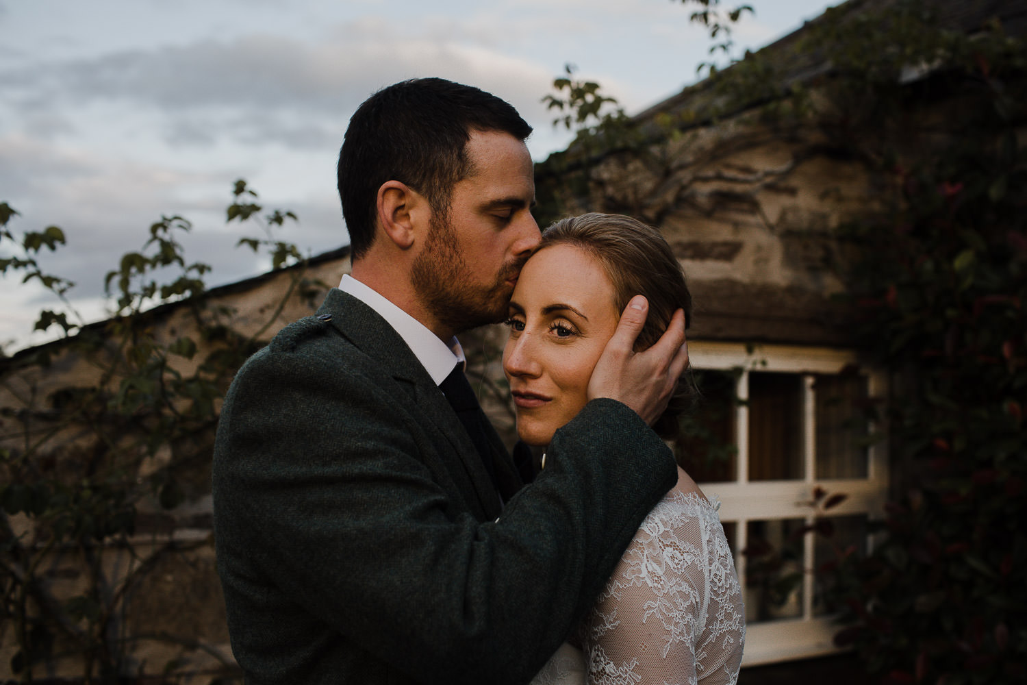 Groom kisses bride in Scotland