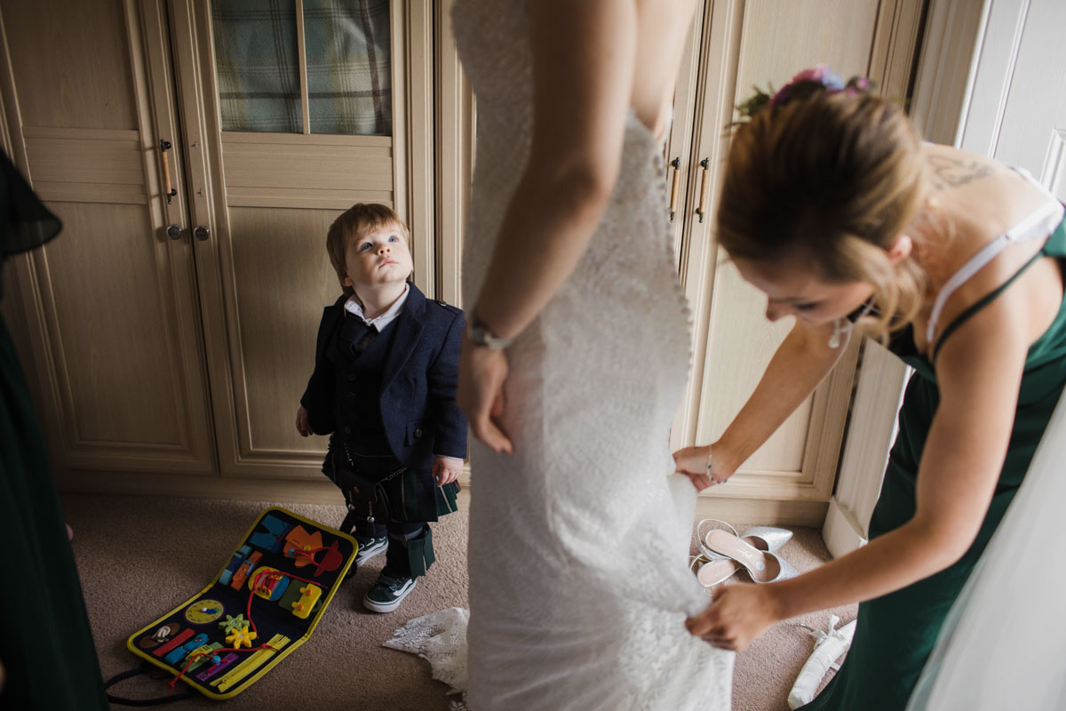 Bride's son watches her get ready for her wedding