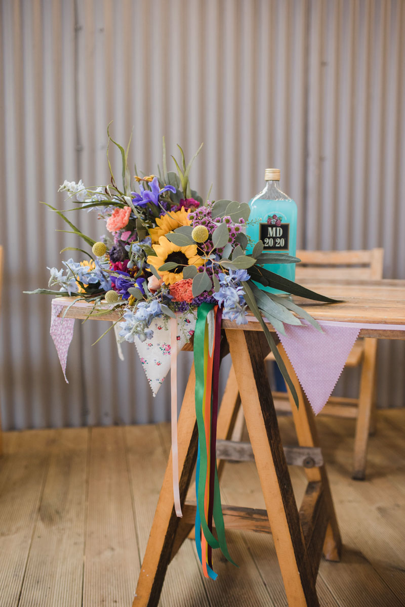 Sunflower bridal bouquet with bottle of mad dog