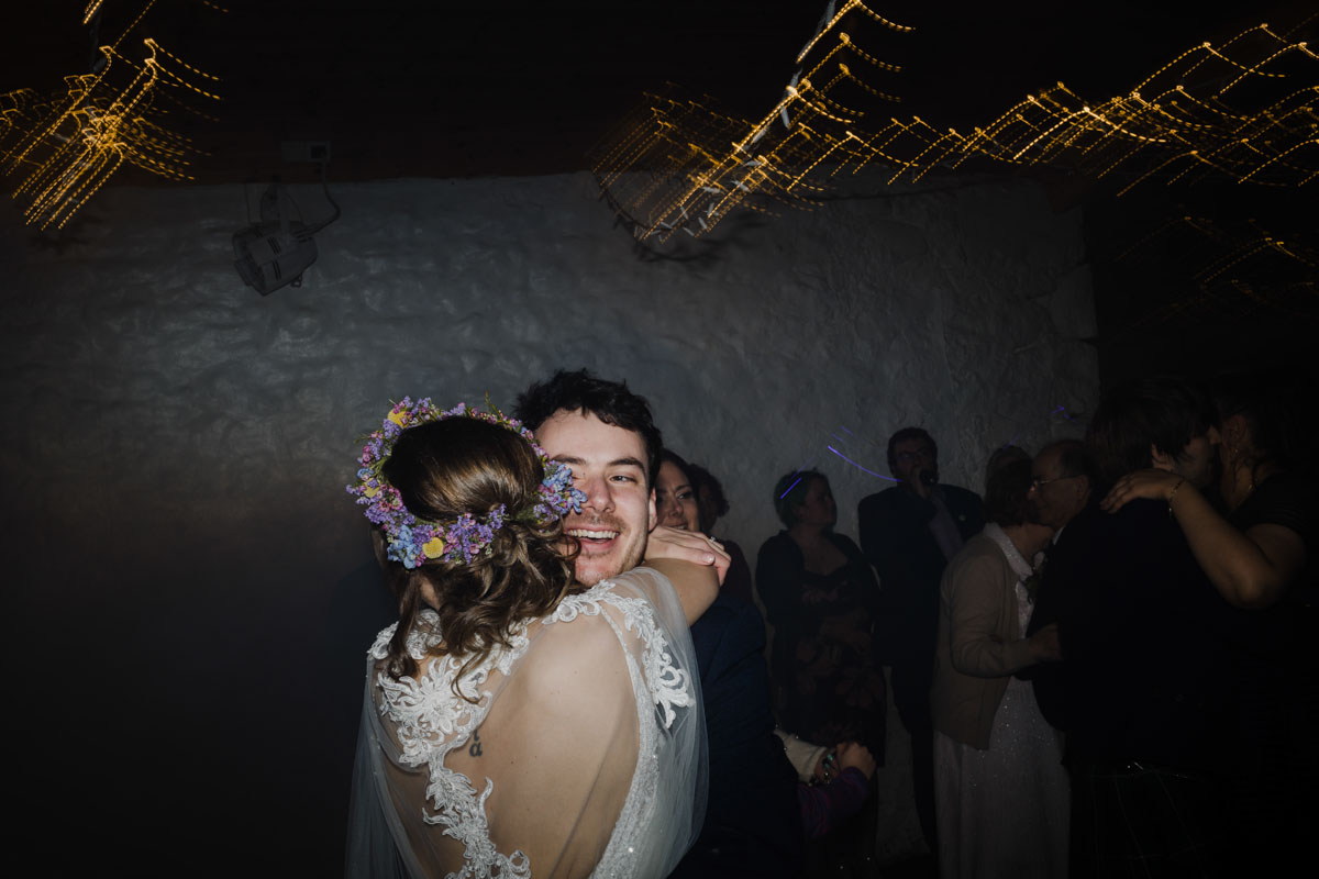 Bride and groom hug during first dance at Scottish wedding