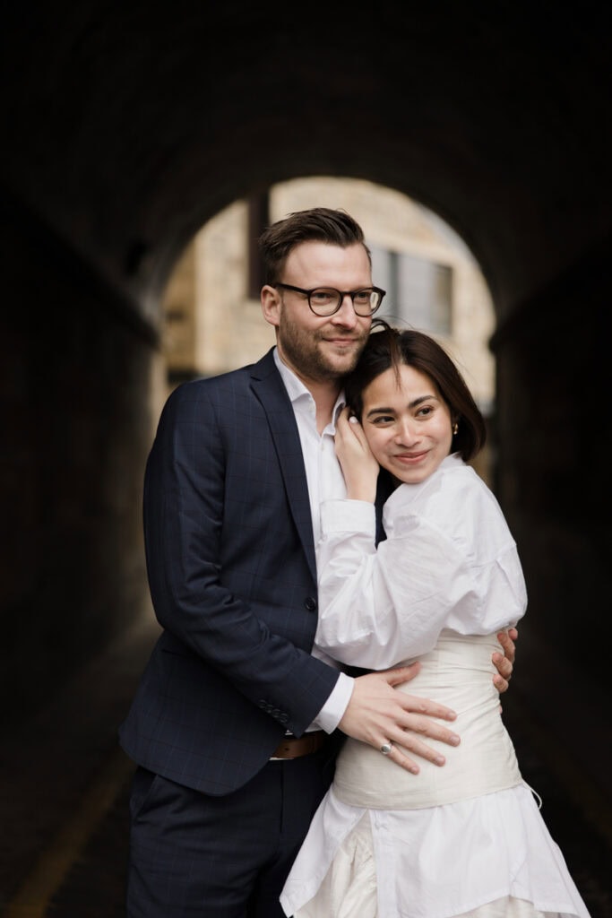 Romantic wedding couple in Scotland under a tunnel, documentary-style photography.