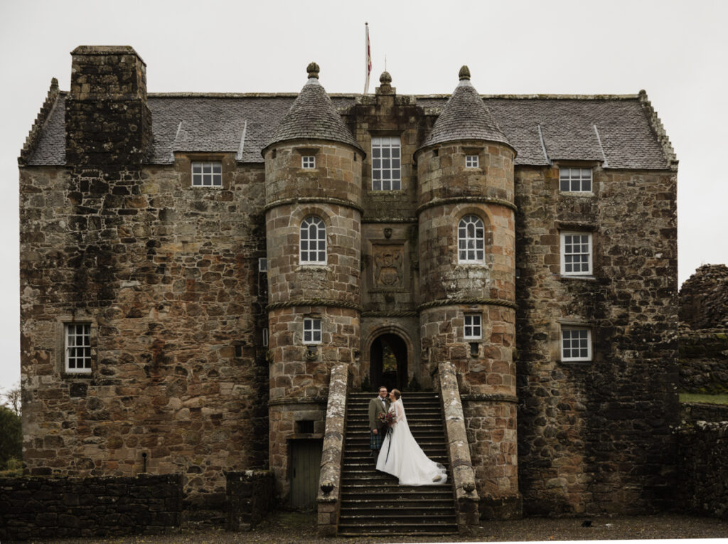 Rowallan old castle with a wedding couple on the stairs