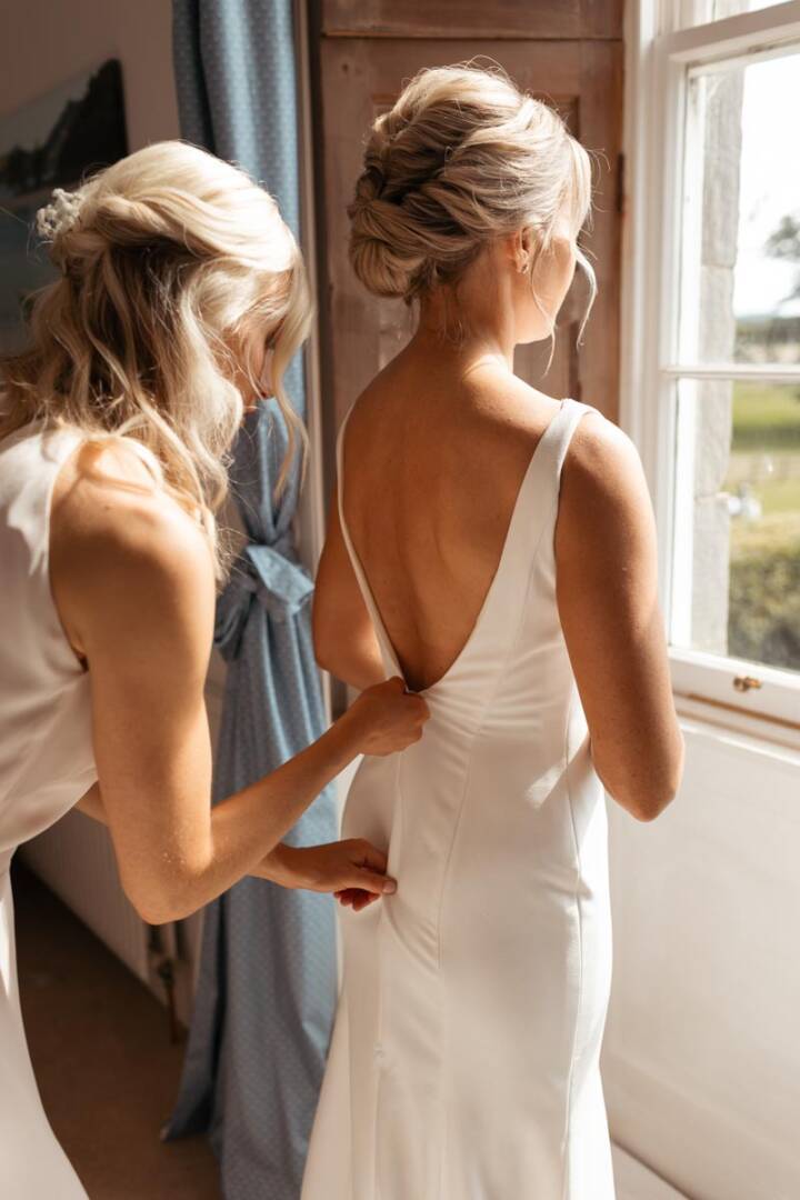 Bride getting ready in a white wedding dress at a Scottish venue.
