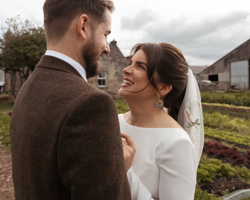 Romantic wedding portrait of bride and groom outdoors in Scotland.