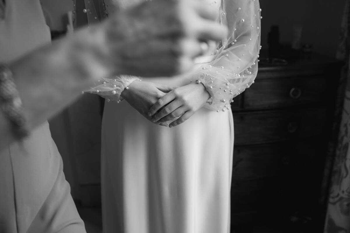 Bride holding a glass, candid moment at a wedding in Scotland.