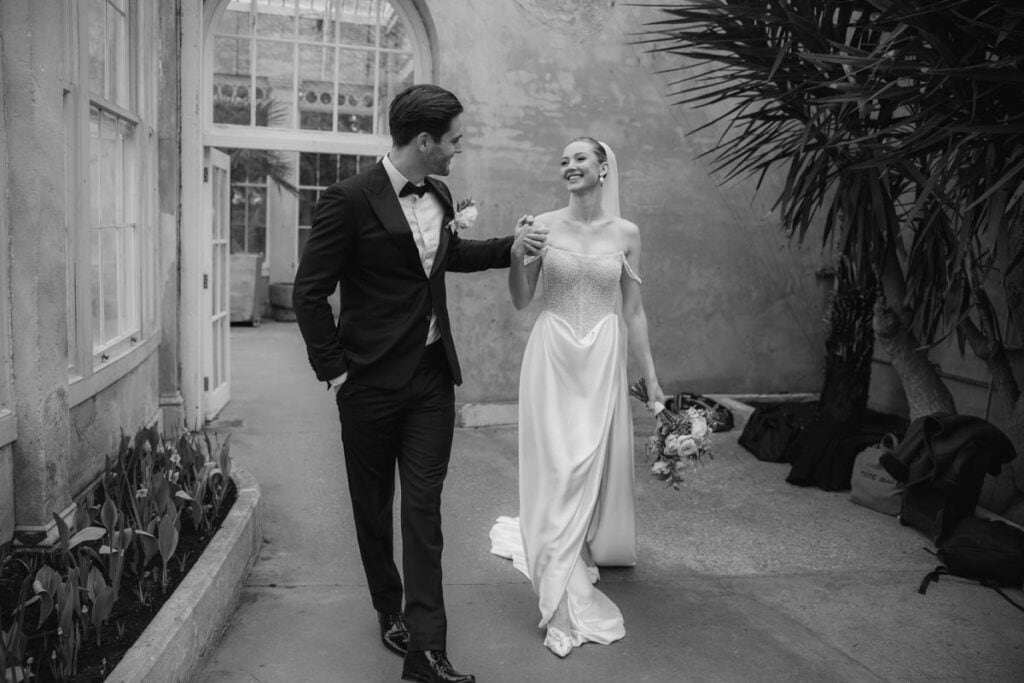 Elegant wedding couple walking indoors at a Scottish venue.